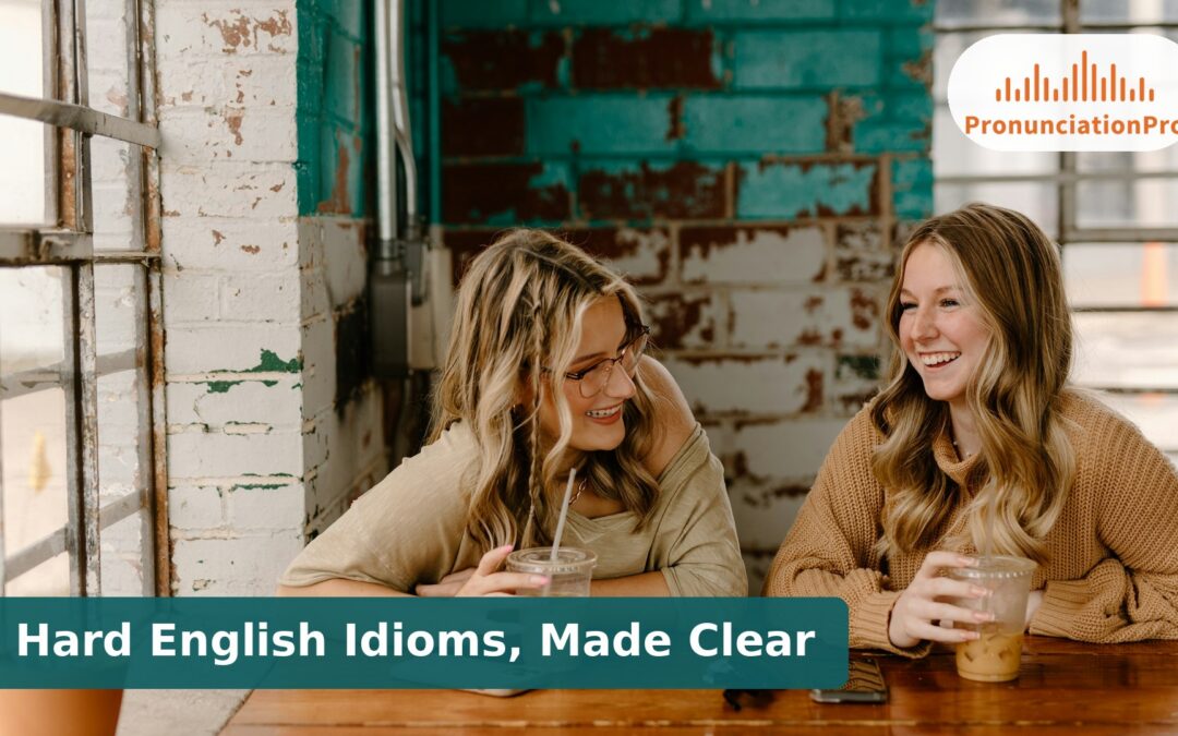 Two friends laughing over iced drinks at a cafe table